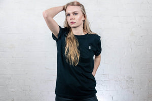 Woman model wearing black Rhetorik T-shirt with Mini-R embroidered