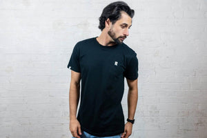 Male model wearing black Rhetorik T-shirt with embroidered logo